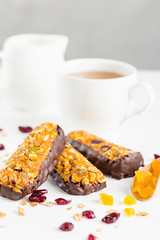 granola bars with dried fruits and honey in chocolate