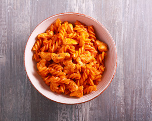 Chicken breast and pasta in tomato sauce, served