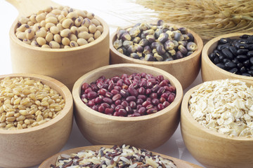 Cereal grains , seeds, beans on wooden background