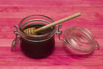 jar buckwheat honey on pink table