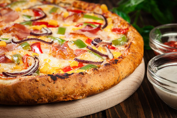 Homemade pizza with bacon, paprika and corn