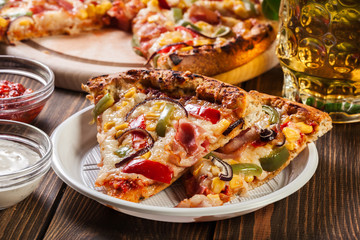 Slices of pizza with bacon, paprika and corn