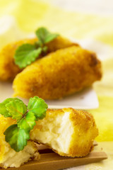 Stuffed croquettes on colorful tablecloth and wooden cutlery