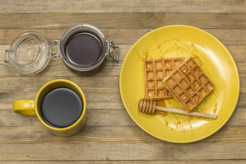 Viennese waffles with mug coffee and jar honey