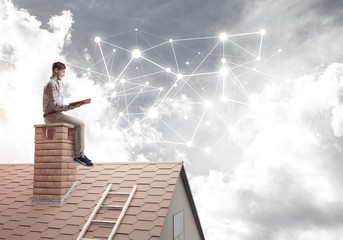 Man on brick roof reading book and concept of social connection