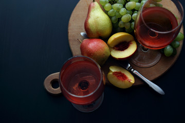 Glasses with pink wine and fruit..