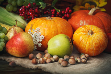 Obraz na płótnie Canvas Happy Thanksgiving Day background, wooden table, decorated with vegetables, fruits and autumn leaves. Autumn background.