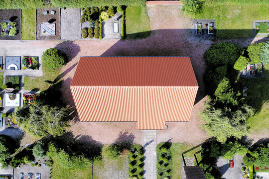 Aerial picture of a chapel on the cemetery near a village