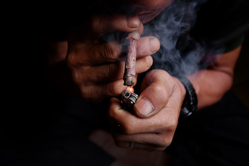 Lighting a tobacco rowed with dry banana leaf.