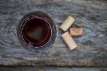 Bottle of wine with corkscrew on wooden background