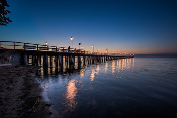 Fototapeta premium Amazing sunrise on the pier at the seaside. Gdynia Orlowo, Poland