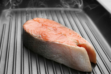 Piece of salmon in grill frying pan, closeup