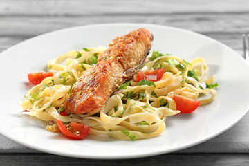 Plate with pasta, salmon and cherry tomatoes, closeup