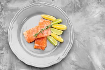 Fresh salmon fillet with rosemary and citrus fruits on plate