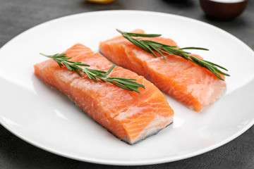 Fresh salmon fillet with rosemary on plate