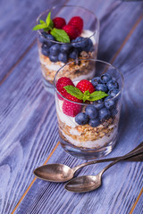 yogurt with muesli and berries on a wooden table