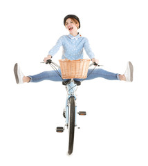 Young smiling girl with bicycle on white background