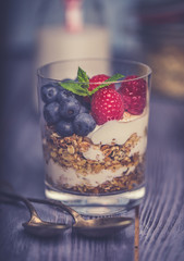 yogurt with muesli and berries on a wooden table