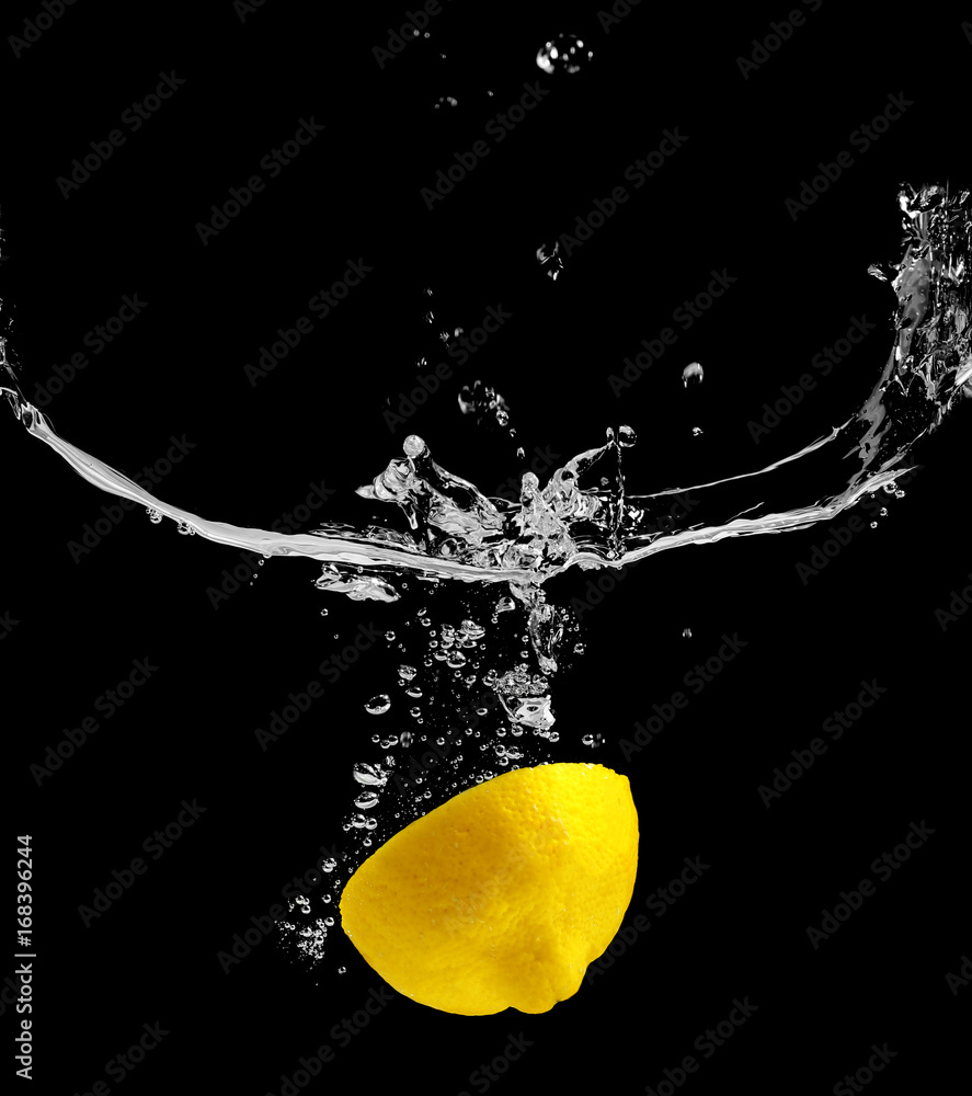 Wall mural fresh lemon in water on black background