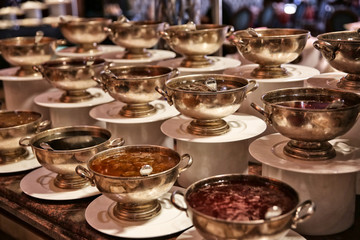 Different kinds of jams in bowls on table at buffet
