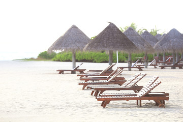 Sun loungers on beach at sea resort