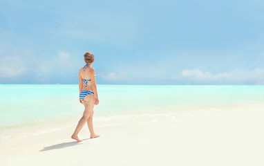 Fototapeta na wymiar Beautiful young woman on sea beach