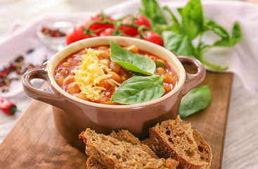 Delicious turkey chili in casserole on wooden table