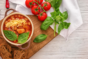 Delicious turkey chili in casserole on wooden table