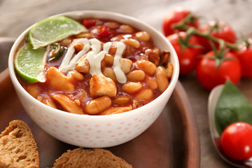 Delicious turkey chili in bowl on table