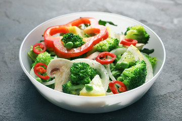 Plate with broccoli salad on table