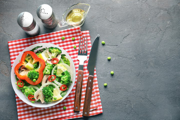 Fototapeta na wymiar Plate with broccoli salad on grey background
