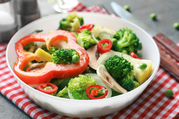 Plate with broccoli salad on table