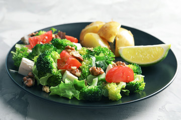 Plate with broccoli salad on table