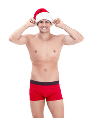 Muscle man in Christmas hat on white background