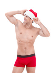 Muscle man in Christmas hat on white background