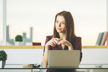 Thoughtful woman drinking coffee