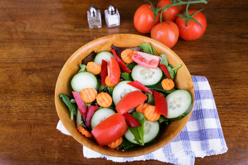 Large Mixed Salad in Wood Bowl with Fresh Tomatoes
