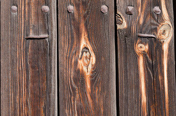 brown wooden boards with rusty nails and iron rivets