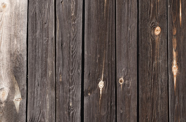 Fototapeta premium dark wooden planks with light spots, are located vertically
