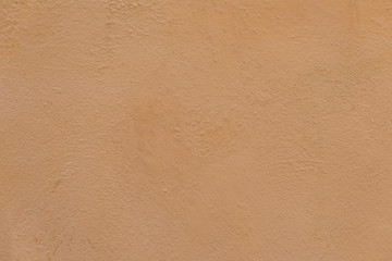 painted orange plaster wall of an old house in the provence