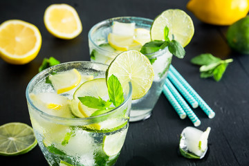 Cold and refreshing infused detox water with lime with lemon in a glass