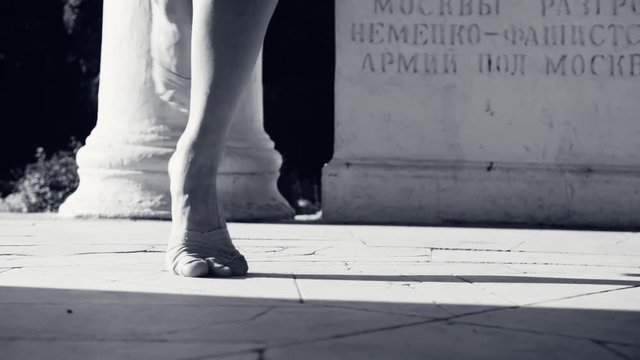 Bare feet of a woman dancing on a stone floor