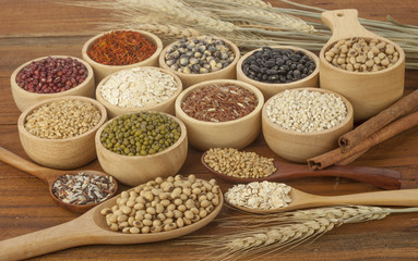 Cereal grains , seeds, beans on wooden background