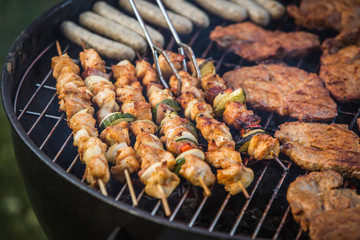 Grilling shashlik and meat on barbecue grill