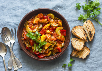 Healthy vegetarian lunch - stewed garden vegetables. Vegetable ratatouille and grilled bread. On a...