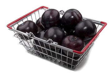 sweet and organic plum in a shopping basket