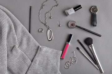 Flat lay with female accessories in gray shades