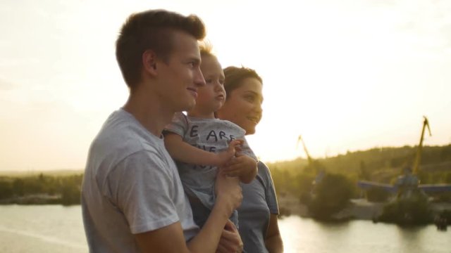 profiles fases of a young happy family with two year old son outdoors