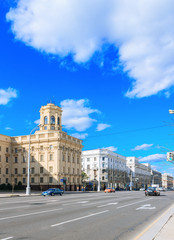 Fototapeta na wymiar Central building kgb in Minsk, Belarus. Classical facade with columns. Blue sky with clouds. City landscape.