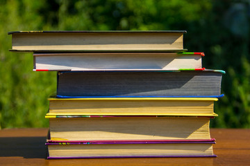 Stack of the books on wooden table outdoor